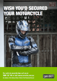 Man in motorcycle helmet standing at a bus stop